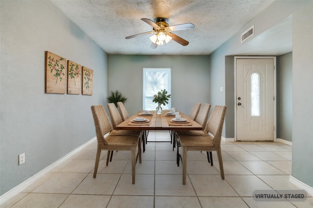 1913 Northwind Ct, Garland, TX 75040 - dining area featuring a textured ceiling, a ceiling fan, and light tile patterned flooring