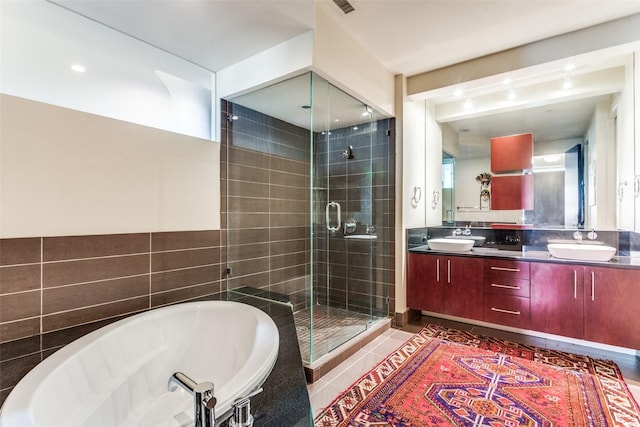 2600 W 7th St Unit 1417, Fort Worth, TX 76107 - full bathroom featuring double vanity, a stall shower, a bath, and tile patterned floors