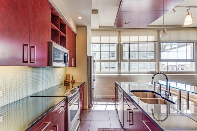 2600 W 7th St Unit 1417, Fort Worth, TX 76107 - kitchen with appliances with stainless steel finishes, dark brown cabinets, tile patterned floors, hanging light fixtures, and decorative backsplash
