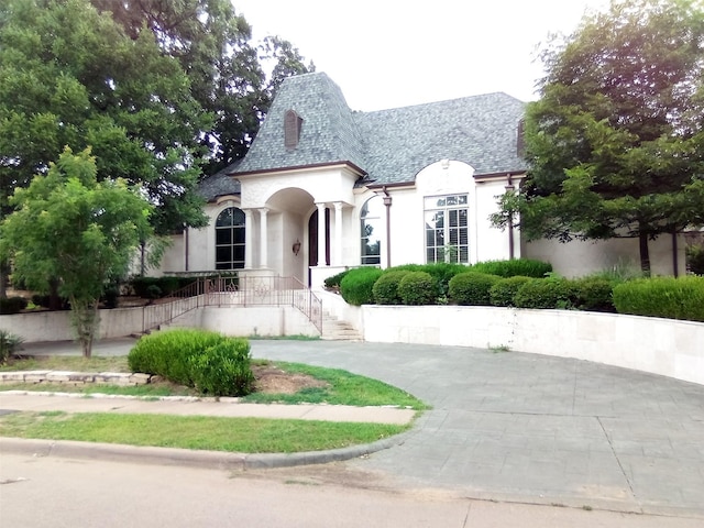 5150 Spanish Oaks Dr, Frisco, TX 75034 - french country inspired facade featuring stucco siding and stairs