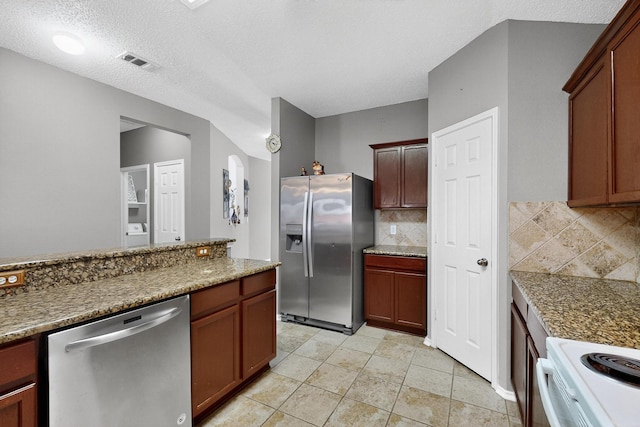 8409 Vicksburg Ln, Fort Worth, TX 76123 - kitchen featuring appliances with stainless steel finishes, decorative backsplash, and a textured ceiling