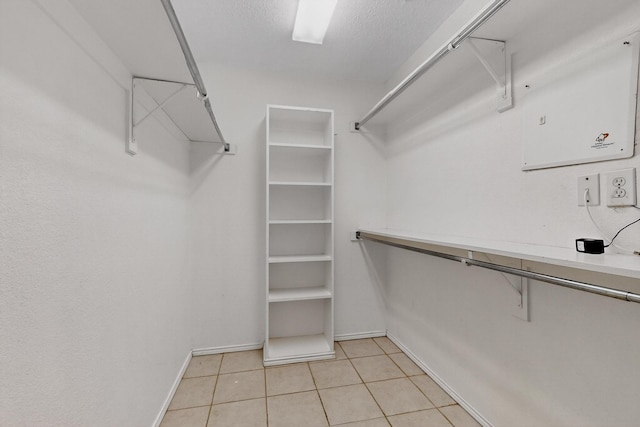 8409 Vicksburg Ln, Fort Worth, TX 76123 - walk in closet with light tile patterned flooring