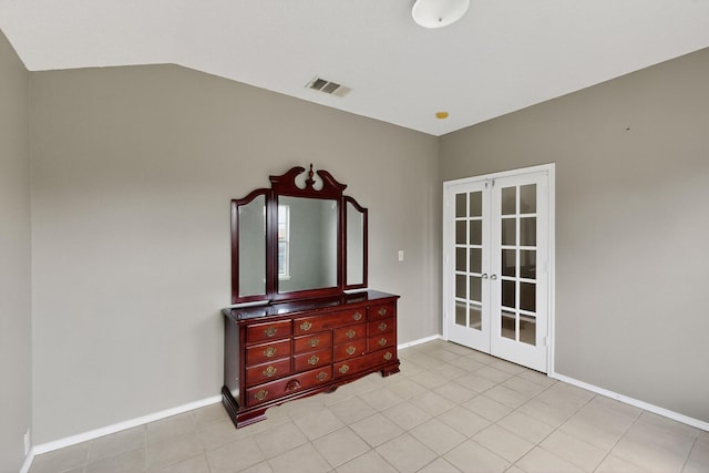 8409 Vicksburg Ln, Fort Worth, TX 76123 - bedroom with french doors, vaulted ceiling, and light tile patterned floors