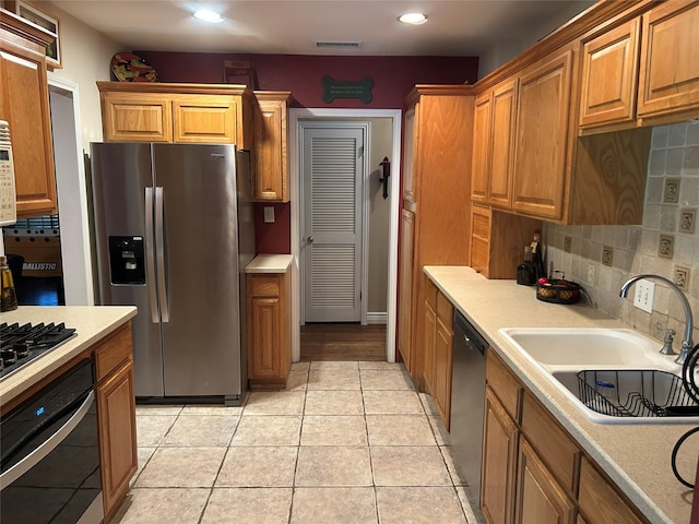 625 N Bailey Ave, Fort Worth, TX 76107 - kitchen featuring appliances with stainless steel finishes, light countertops, decorative backsplash, recessed lighting, and brown cabinetry