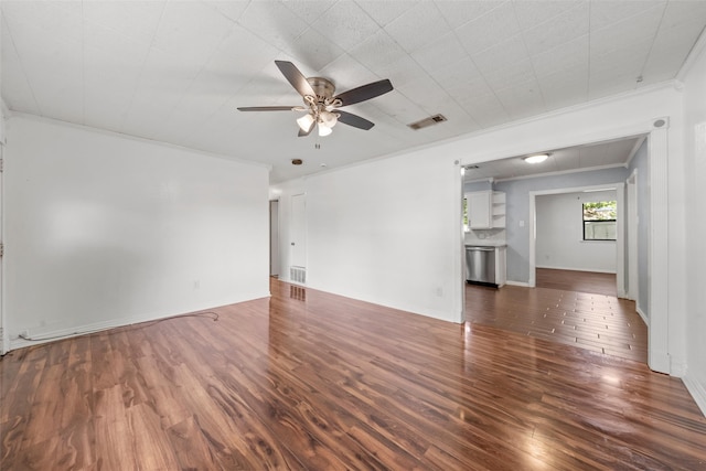 210 Virginia Dr, Waco, TX 76705 - unfurnished living room featuring a ceiling fan, dark wood-style flooring, and crown molding