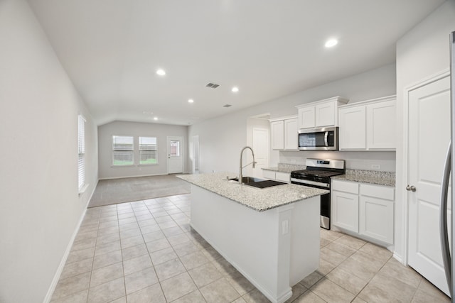 124 Greengate Dr, Boyd, TX 76023 - kitchen with stainless steel appliances, light tile patterned floors, recessed lighting, a center island with sink, and light stone counters