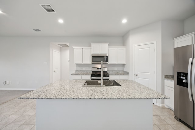 124 Greengate Dr, Boyd, TX 76023 - kitchen featuring appliances with stainless steel finishes, white cabinets, a center island with sink, recessed lighting, and light tile patterned floors