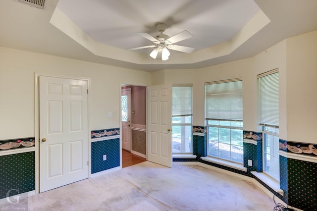 8 Sterling Ranch Rd N, Haughton, LA 71037 - unfurnished bedroom featuring light carpet, wainscoting, multiple windows, and a raised ceiling