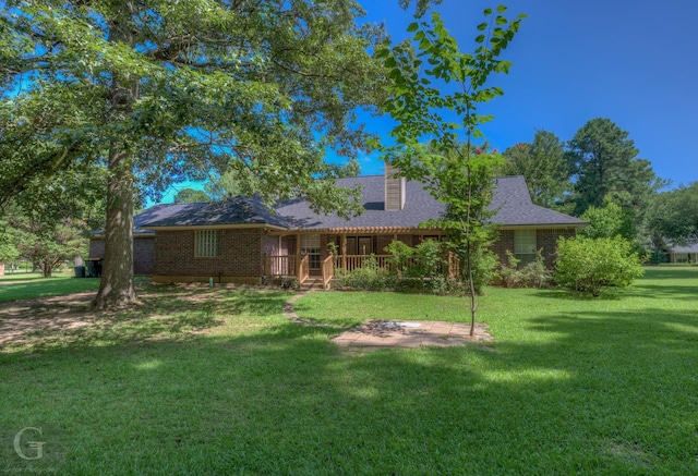 8 Sterling Ranch Rd N, Haughton, LA 71037 - view of front facade featuring a front lawn, brick siding, a deck, and a chimney