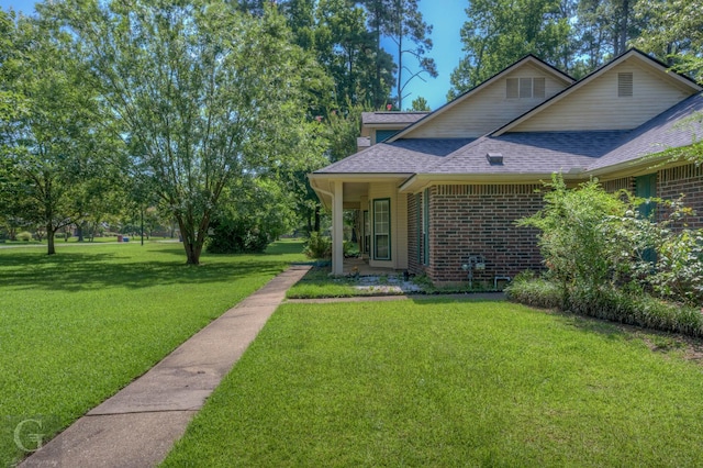 8 Sterling Ranch Rd N, Haughton, LA 71037 - view of front of property featuring roof with shingles, a front yard, and brick siding