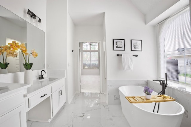401 Wolverley Ln, Allen, TX 75002 - full bathroom featuring marble tiled floors, double vanity, a freestanding bath, and lofted ceiling