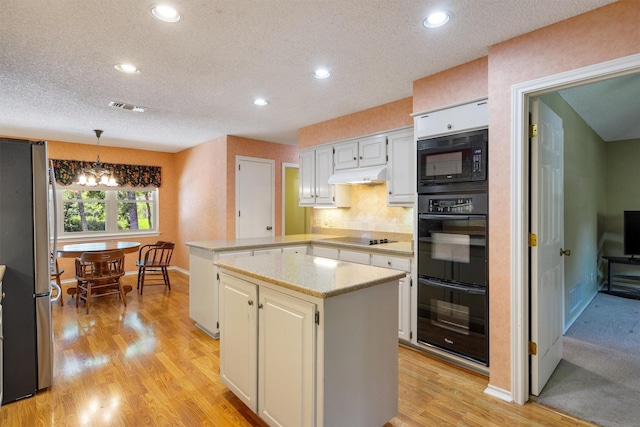2815 Whisperwood Trl, Dalworthington Gardens, TX 76016 - kitchen with black appliances, a peninsula, under cabinet range hood, recessed lighting, and light wood-type flooring