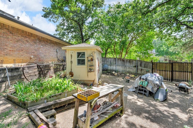 2815 Whisperwood Trl, Dalworthington Gardens, TX 76016 - fenced backyard featuring a vegetable garden and a storage shed