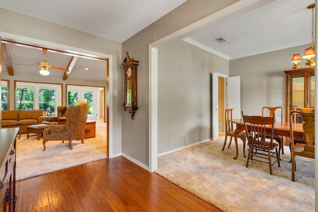 2815 Whisperwood Trl, Dalworthington Gardens, TX 76016 - dining room featuring dark wood-style flooring, a textured ceiling, ceiling fan, and beam ceiling