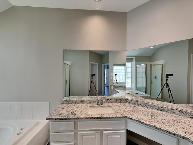 2829 Alcot Ln, Grand Prairie, TX 75052 - bathroom featuring lofted ceiling, a garden tub, a stall shower, vanity, and recessed lighting