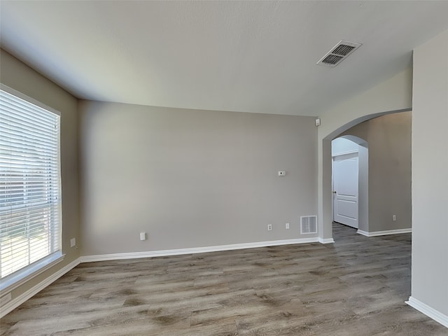 2829 Alcot Ln, Grand Prairie, TX 75052 - unfurnished room featuring arched walkways and wood finished floors