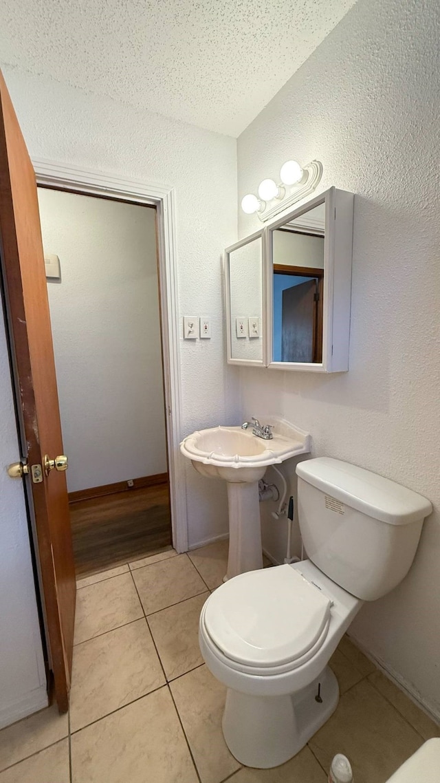 227 W Center St, Duncanville, TX 75116 - bathroom with tile patterned flooring and a textured wall