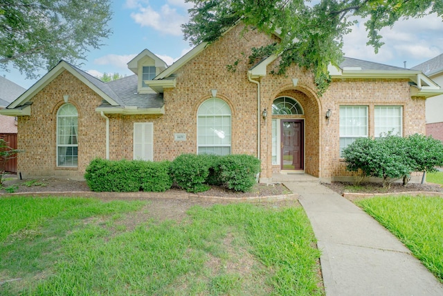 8479 Firewheel Ln, Frisco, TX 75036 - traditional-style house with a shingled roof and brick siding