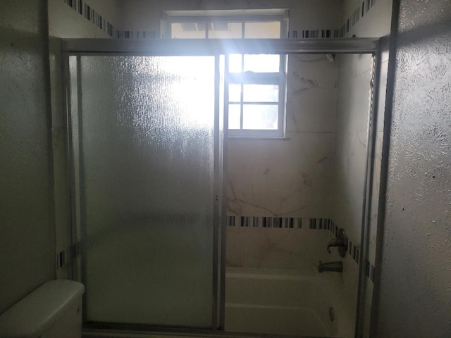 734 Sceptre Cir, Garland, TX 75043 - full bath with healthy amount of natural light and bath / shower combo with glass door