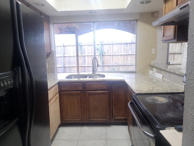 734 Sceptre Cir, Garland, TX 75043 - kitchen featuring fridge with ice dispenser, black electric range oven, light tile patterned floors, and under cabinet range hood