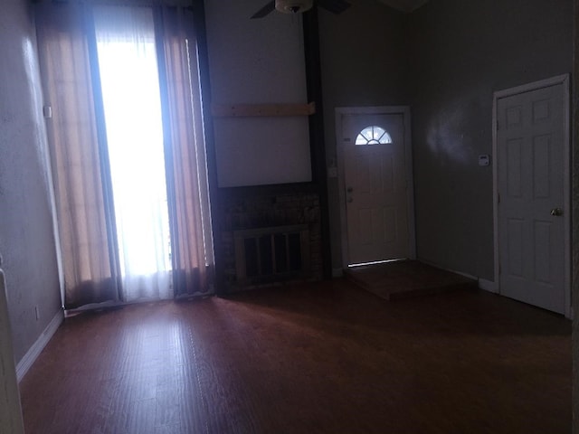 734 Sceptre Cir, Garland, TX 75043 - entryway with ceiling fan, wood finished floors, and a brick fireplace