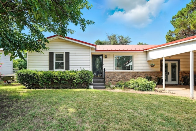 1017 2nd St, Hamlin, TX 79520 - single story home featuring brick siding, a front yard, and a metal roof