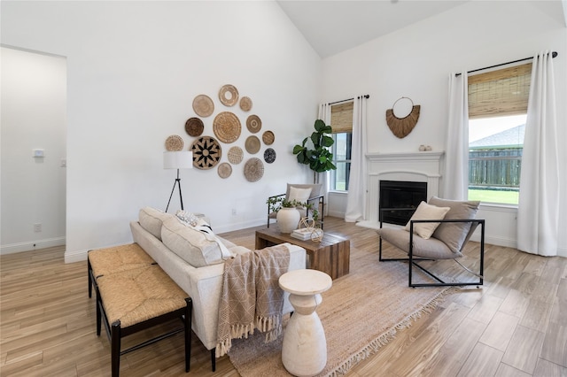 1604 Berry Ridge Trl, Aubrey, TX 76227 - living room featuring a fireplace, light wood-style flooring, and high vaulted ceiling