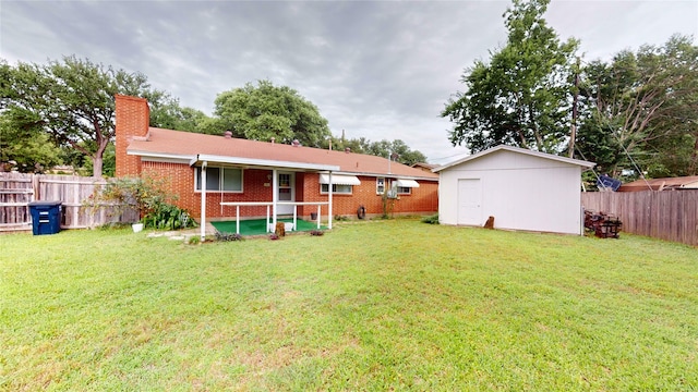1550 Pamela Ln, Fort Worth, TX 76112 - rear view of house featuring a chimney, a fenced backyard, brick siding, and an outdoor structure