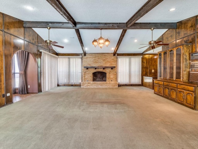 1425 Meyers Rd, Irving, TX 75060 - unfurnished living room with ceiling fan, carpet flooring, a fireplace, wood walls, and a chandelier