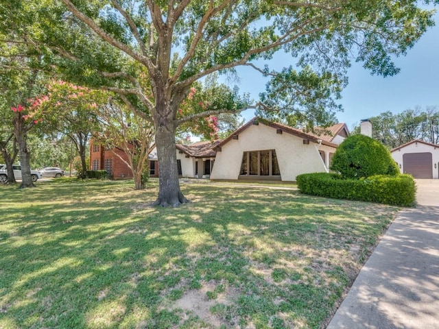 1425 Meyers Rd, Irving, TX 75060 - view of front facade featuring a front lawn, stucco siding, and a chimney