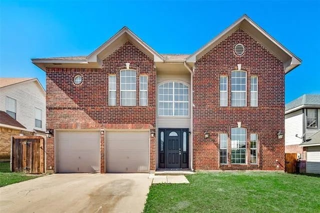 4914 Redwater Dr, Arlington, TX 76018 - traditional-style house with brick siding, driveway, an attached garage, and a front yard