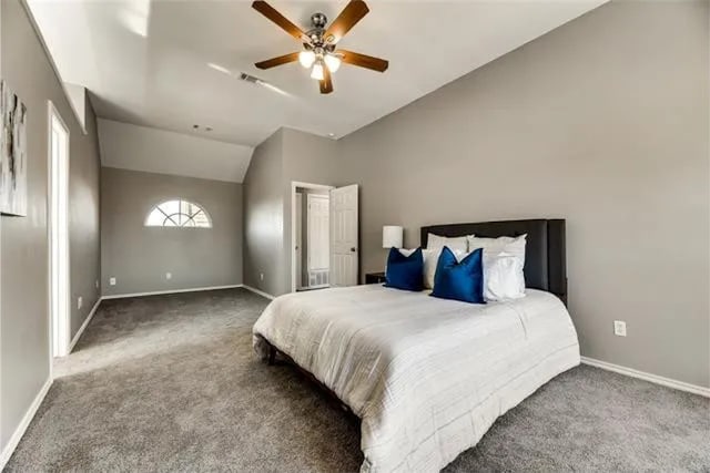 4914 Redwater Dr, Arlington, TX 76018 - carpeted bedroom with lofted ceiling and a ceiling fan