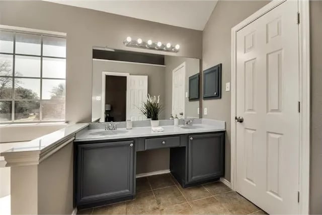 4914 Redwater Dr, Arlington, TX 76018 - full bathroom with double vanity, lofted ceiling, and tile patterned flooring