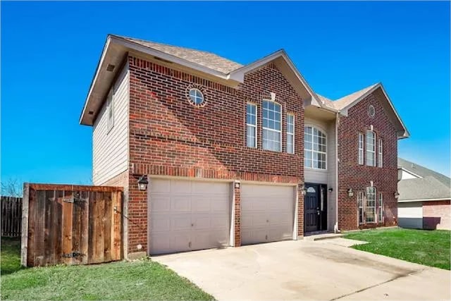 4914 Redwater Dr, Arlington, TX 76018 - traditional-style house featuring brick siding, driveway, and an attached garage