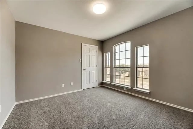 4914 Redwater Dr, Arlington, TX 76018 - carpeted empty room with baseboards