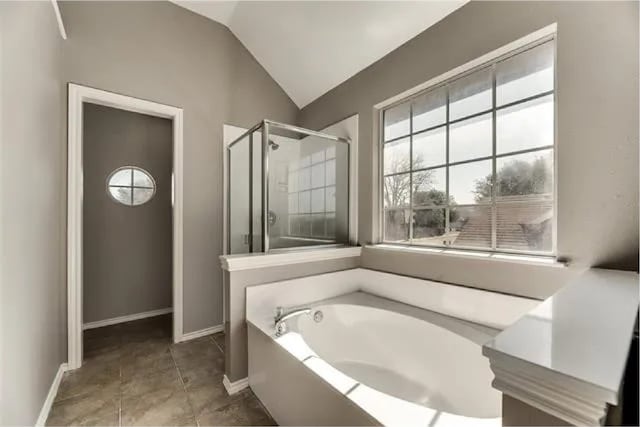 4914 Redwater Dr, Arlington, TX 76018 - full bathroom featuring a bath, a stall shower, and vaulted ceiling