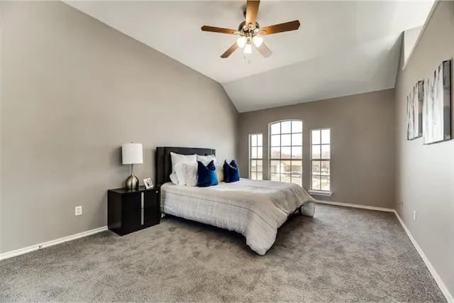 4914 Redwater Dr, Arlington, TX 76018 - carpeted bedroom featuring vaulted ceiling and ceiling fan