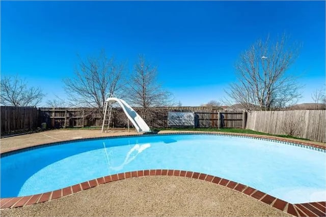 4914 Redwater Dr, Arlington, TX 76018 - view of swimming pool featuring a water slide and a fenced backyard