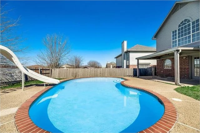 4914 Redwater Dr, Arlington, TX 76018 - view of swimming pool with a water slide, a fenced backyard, and a patio