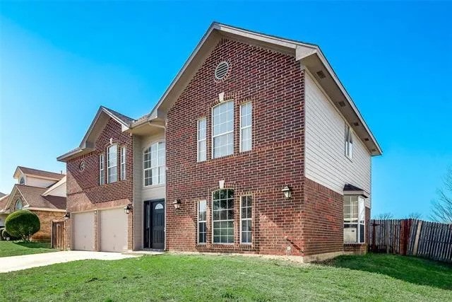4914 Redwater Dr, Arlington, TX 76018 - traditional-style house with brick siding, driveway, and a garage