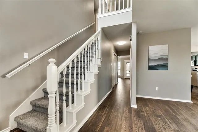 4914 Redwater Dr, Arlington, TX 76018 - staircase with wood finished floors and baseboards