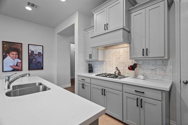 3700 Blue Stream Dr, Little Elm, TX 75068 - kitchen with stainless steel gas cooktop, decorative backsplash, light countertops, recessed lighting, and gray cabinets