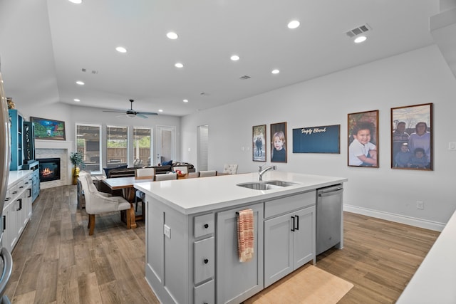 3700 Blue Stream Dr, Little Elm, TX 75068 - kitchen featuring dishwasher, an island with sink, light wood finished floors, open floor plan, and recessed lighting