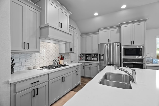 3700 Blue Stream Dr, Little Elm, TX 75068 - kitchen featuring stainless steel appliances, decorative backsplash, light countertops, lofted ceiling, and extractor fan