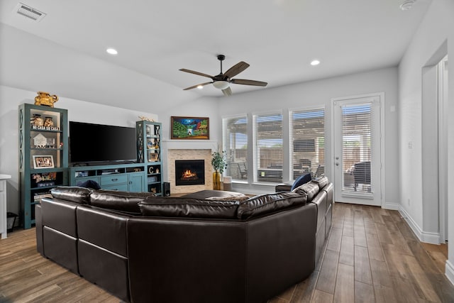 3700 Blue Stream Dr, Little Elm, TX 75068 - living area featuring a warm lit fireplace, a ceiling fan, wood finished floors, and recessed lighting