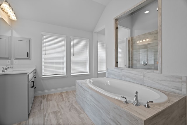 3700 Blue Stream Dr, Little Elm, TX 75068 - bathroom with vanity, a garden tub, vaulted ceiling, and tiled shower