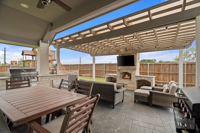 3700 Blue Stream Dr, Little Elm, TX 75068 - fenced backyard with exterior kitchen, a patio area, a pergola, an outdoor living space with a fireplace, and ceiling fan