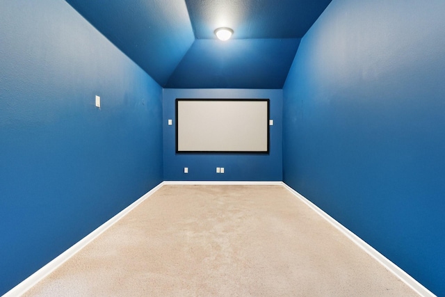 1009 Chickasaw Dr, Carrollton, TX 75010 - carpeted home theater room with vaulted ceiling and baseboards