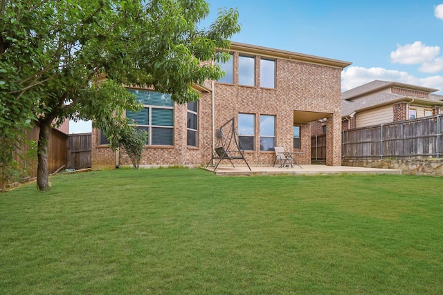 1009 Chickasaw Dr, Carrollton, TX 75010 - back of property with a patio area, a fenced backyard, and brick siding