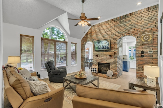 3252 Shady Glen Dr, Grapevine, TX 76051 - living area featuring ceiling fan, healthy amount of natural light, arched walkways, a textured ceiling, and vaulted ceiling